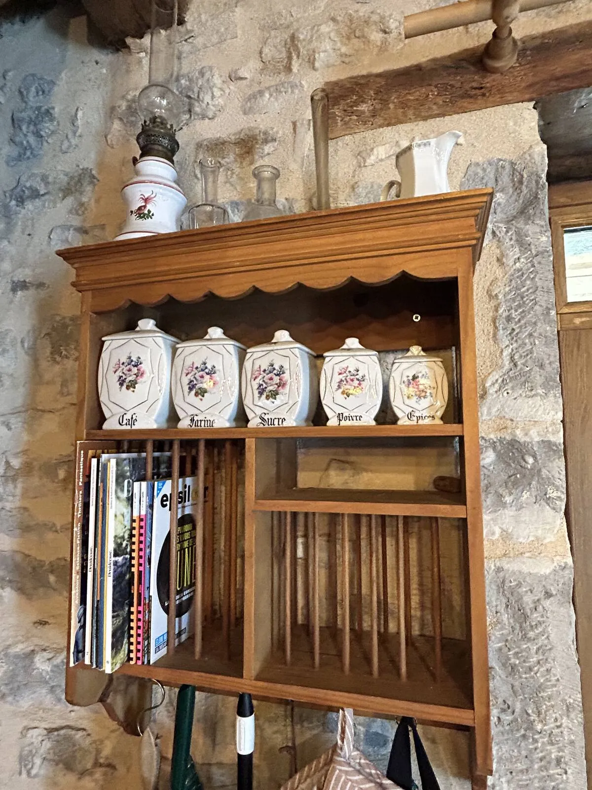 Shelf with bottles and glasses on a stone wall