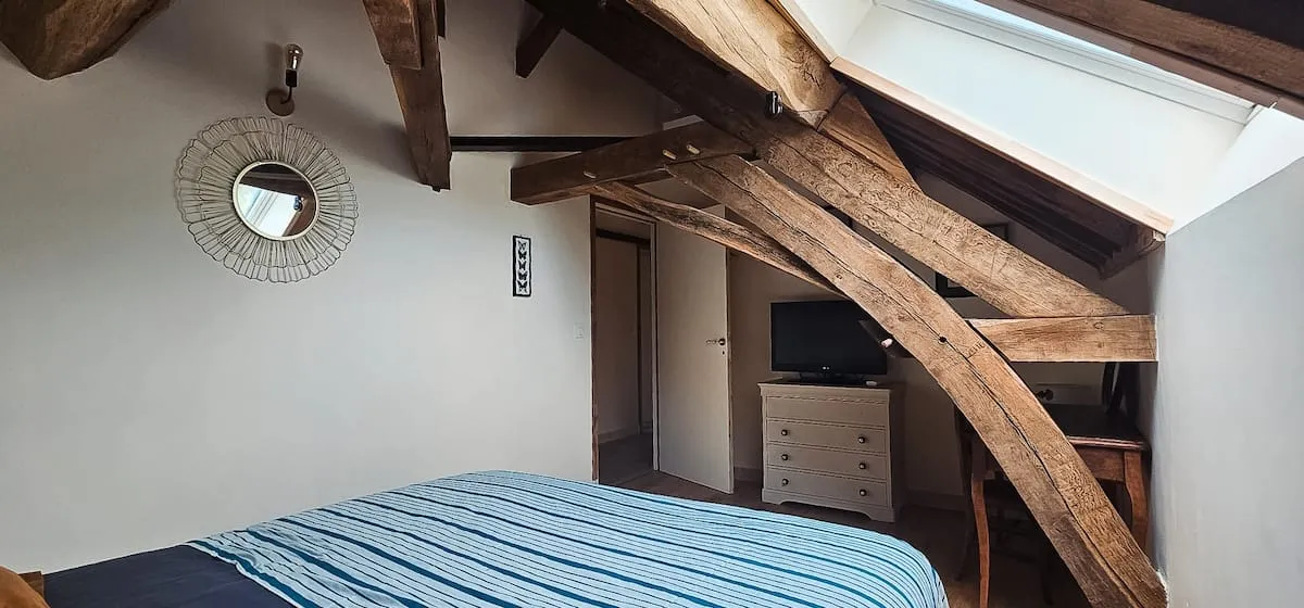 Attic bedroom with blue bedspread