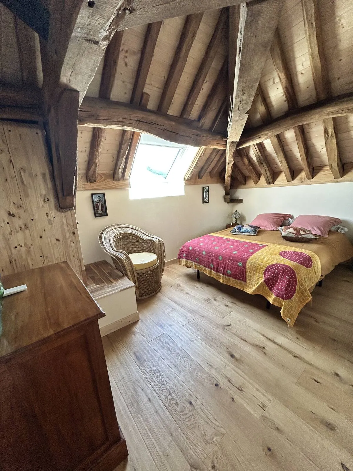 Family bedroom with exposed beams and striped bedding