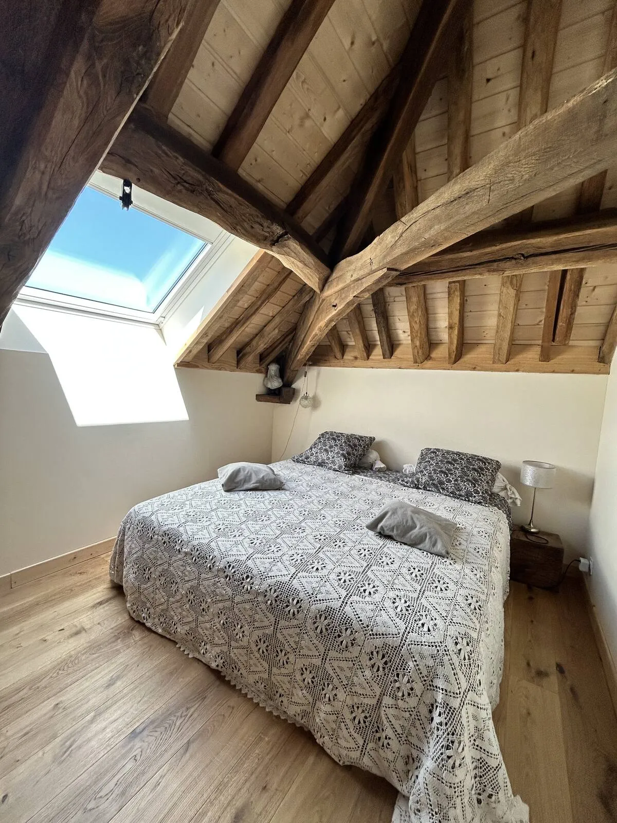Attic bedroom with neutral-toned bedding