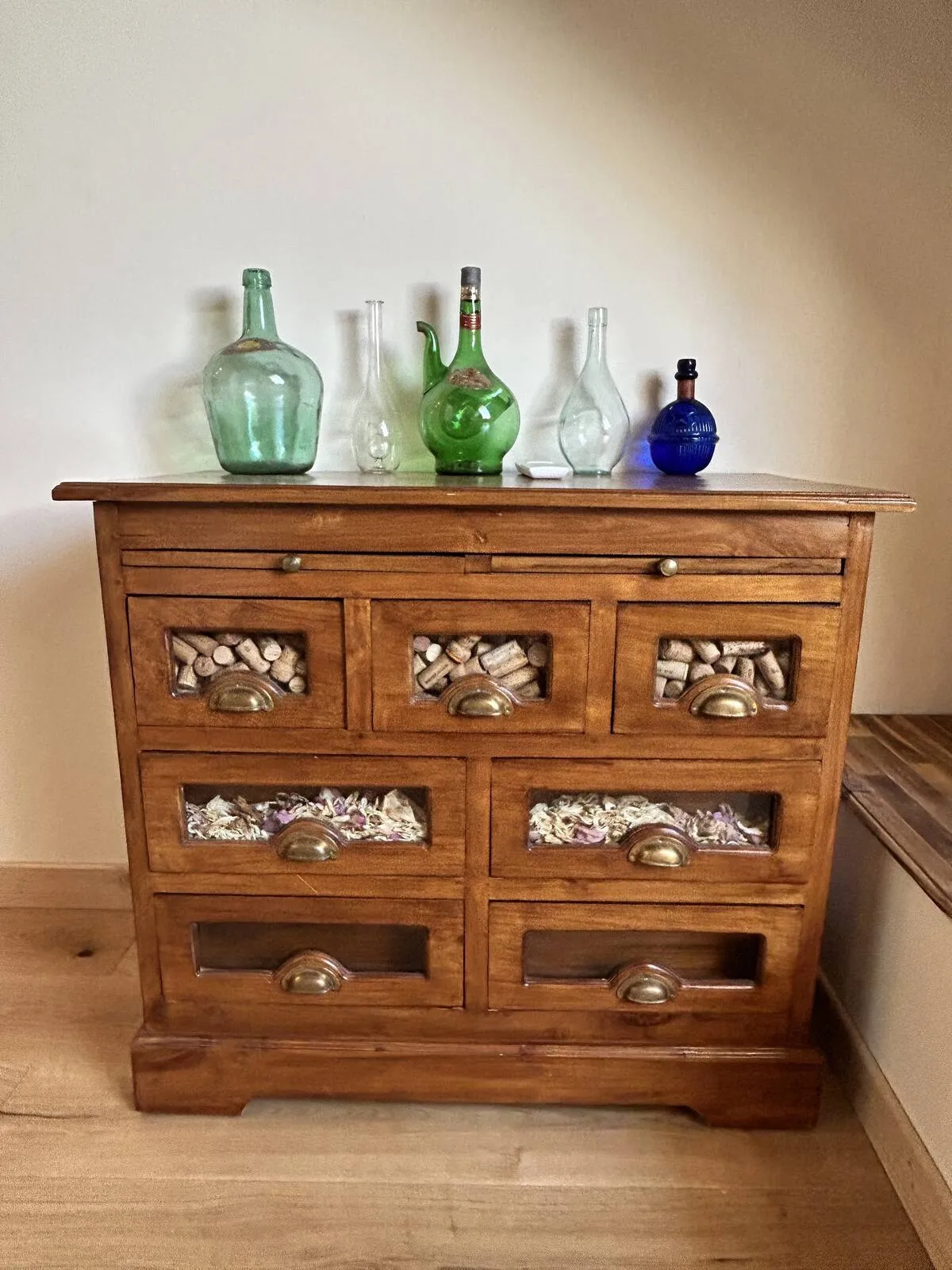 Antique chest of drawers with glass bottles