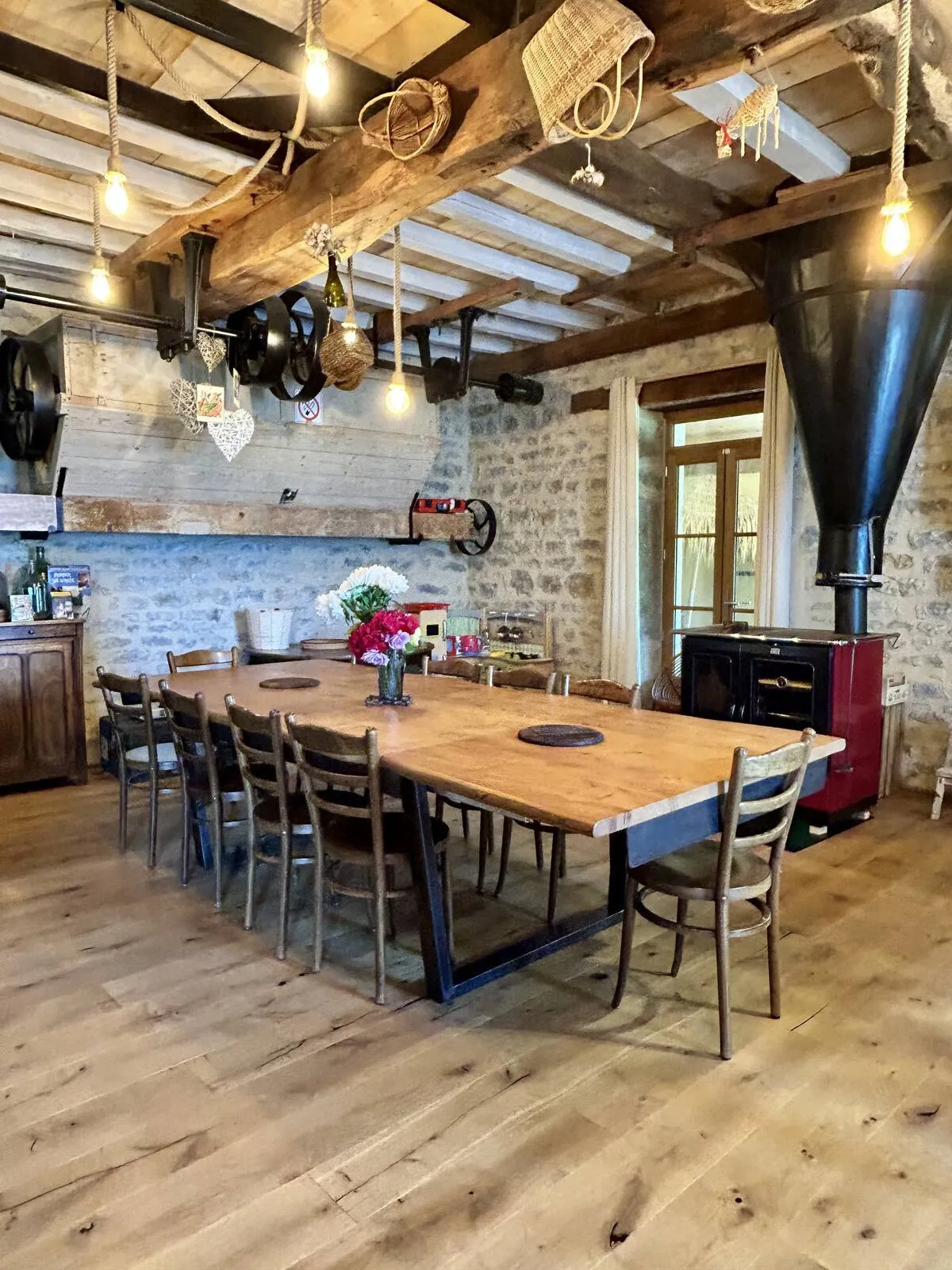 Large convivial dining table set beneath the beams