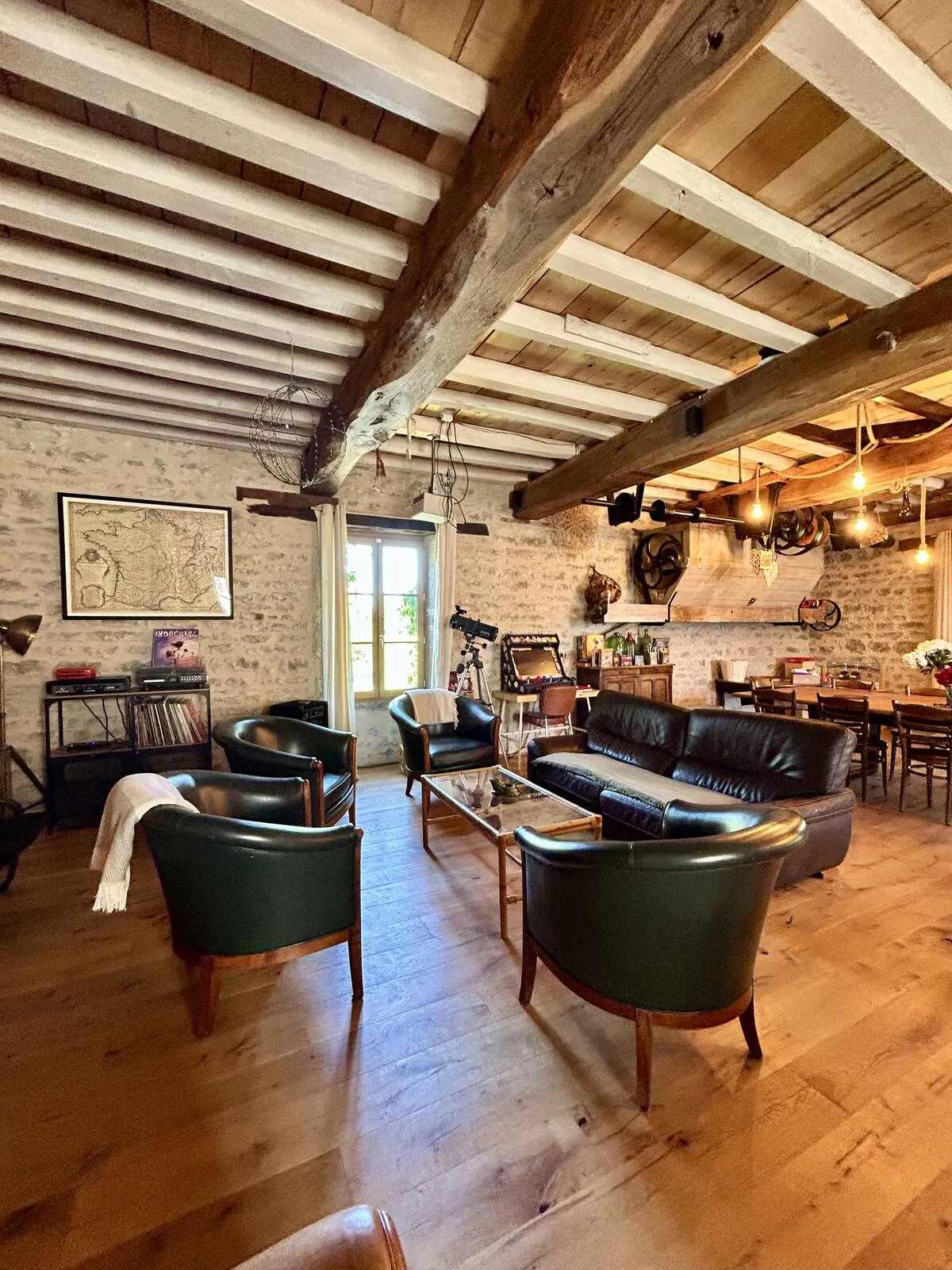 Lounge with leather armchairs and sofas under timber framing