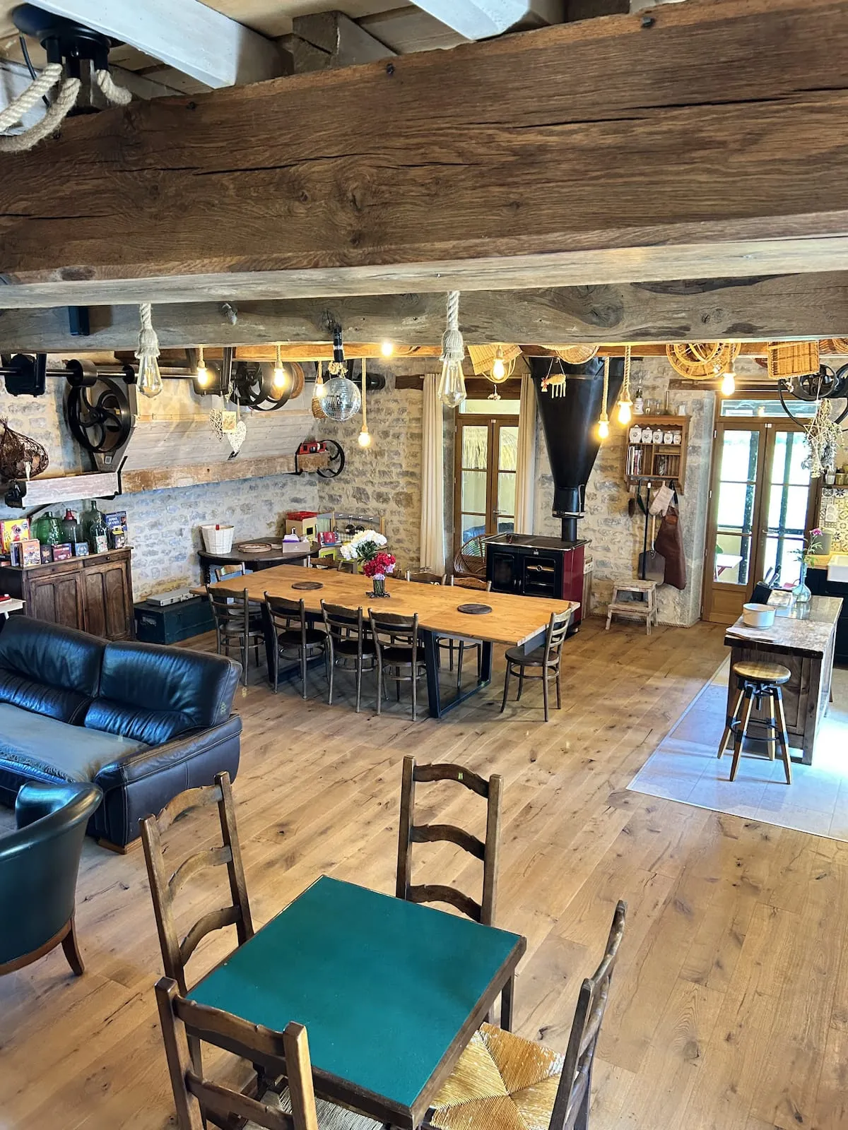 Living area with large wooden table and exposed beams